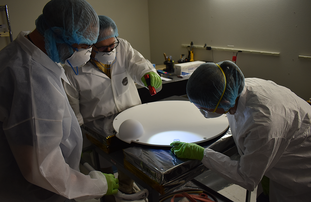 The install team inspects the Acusil mold. Courtesy Peraton.