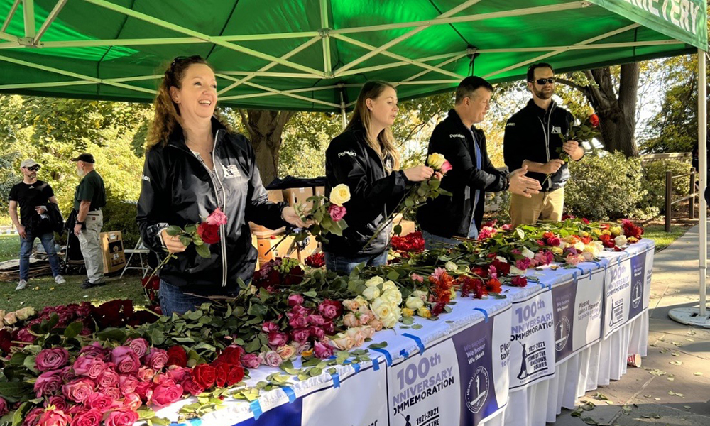 Peraton employees hand out flowers at the Tomb of the Unknown Soldier