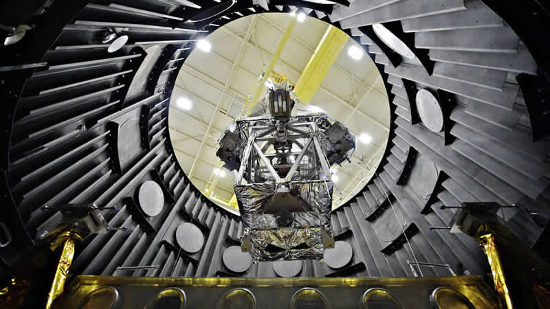 The Optical Telescope Element Simulator, being lowered into the Space Environment Simulator vacuum chamber via crane to be tested to withstand the cold temperatures of space.